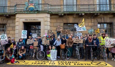 Activists with bicycles pictured in front of the Guildhall in Cambridge